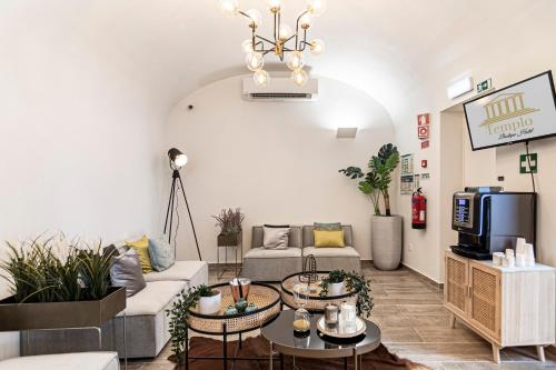 a living room with a couch and tables at Templo Boutique Hotel in Évora