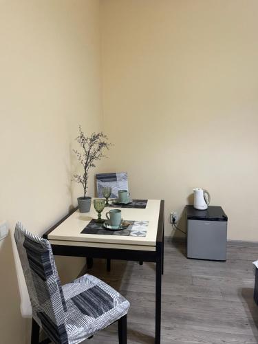 a table and a chair in a room at Your apartment City Center Lviv in Lviv