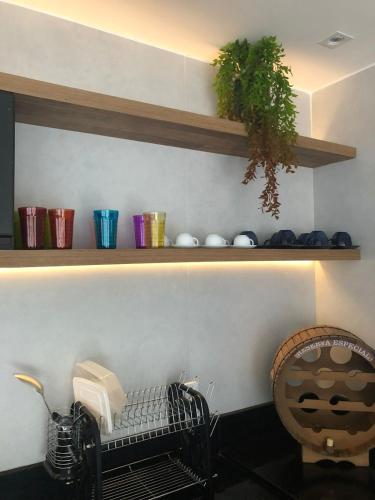 a kitchen with a shelf with books and a chair at Chalé lindo para toda família nas montanhas !!! in Domingos Martins