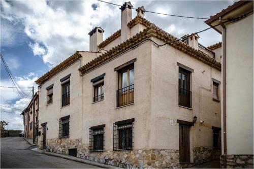 a large building with windows on a street at Ciudad Encantada Tio Daniel in Valdecabras