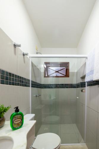 a bathroom with a shower with a toilet and a sink at Pousada Casario in Paraty