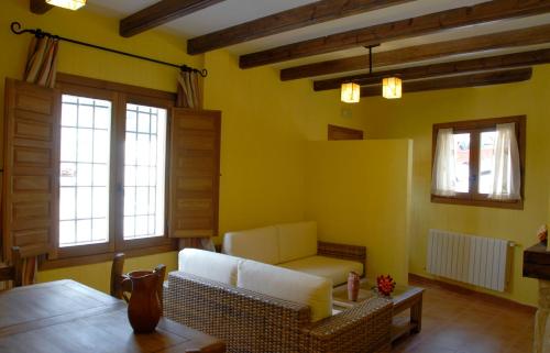 a living room with a couch and two windows at Ciudad Encantada Tio Daniel in Valdecabras