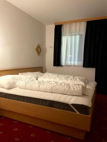 a large bed in a bedroom with a window at Apartment Heijerhof - Top 6 in Wagrain
