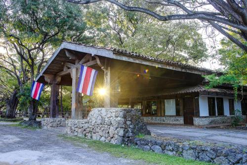 a building with two flags in front of it at Hacienda La Pacífica Eco-Lodge in Cañas
