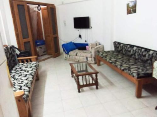 a living room with two couches and a tv at شاليه بقرية أندلسيه بمطروح يرى البحر in Marsa Matruh