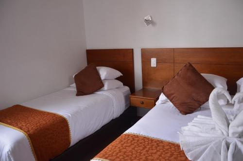 Postel nebo postele na pokoji v ubytování Hotel Santiago Diaz Piedrahita