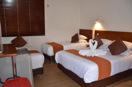 Postel nebo postele na pokoji v ubytování Hotel Santiago Diaz Piedrahita
