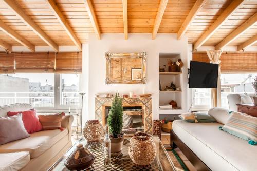 a living room with a couch and a fireplace at Σοφίτα Μοναδικής Αύρας με Θέα & BBQ in Athens