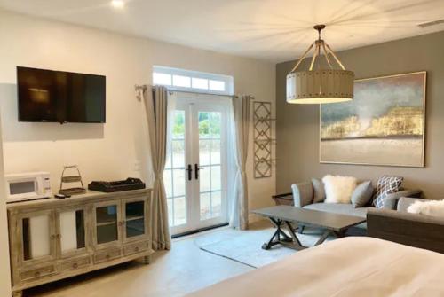 a living room with a couch and a tv at Domaine Chardonnay in Temecula