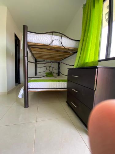 a room with a bunk bed with a dresser and a window at HV Sueño Real Tatacoa in Villavieja
