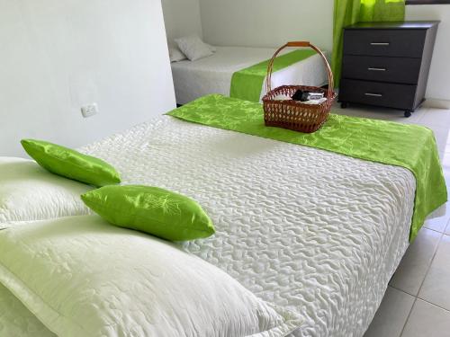 a bedroom with two beds with a basket on top at HV Sueño Real Tatacoa in Villavieja