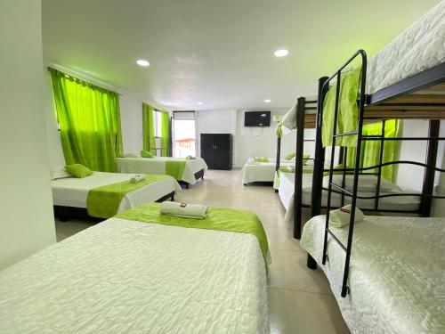 a bedroom with three bunk beds and a living room at HV Sueño Real Tatacoa in Villavieja