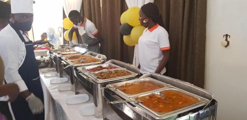 a buffet line with many different types of food at Northern Pearl in Gulu