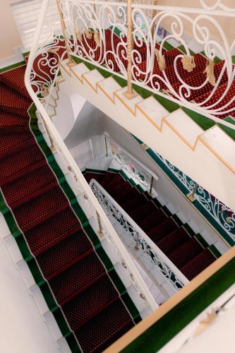 an open stairwell with red and green tiles at Boutique Hotel Silk Way in Türkistan