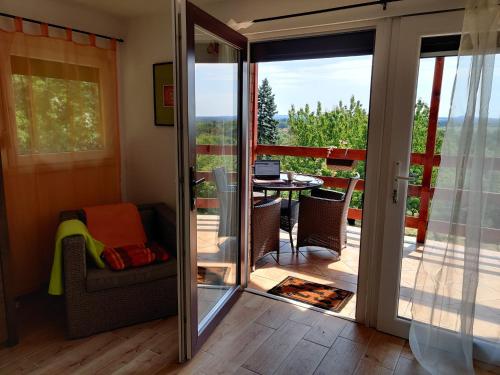 a room with a sliding glass door leading to a balcony at Krisztina Vendégház Leányfalu - Különálló - itt csak Ti vagytok in Leányfalu