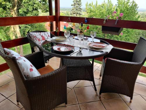 a dining table and chairs on a patio with a view at Krisztina Vendégház Leányfalu - Különálló - itt csak Ti vagytok in Leányfalu