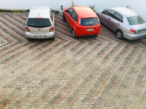 three cars parked on top of a brick roof at Asante’s Guest House in Calcutta