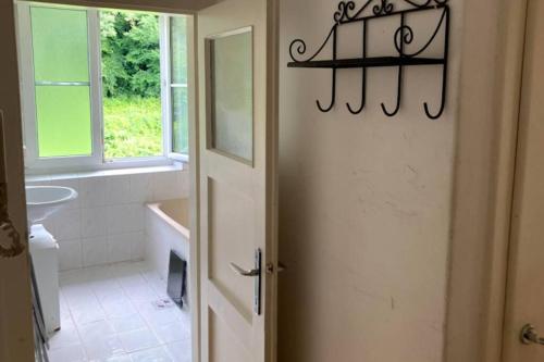 a bathroom with a sink and a toilet and a window at Cozy Condo close to town, castle, lake and hiking in Wolfsberg