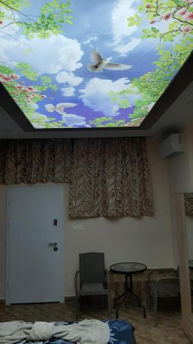 a room with a ceiling with a painting on it at АРт 1 in Sliven