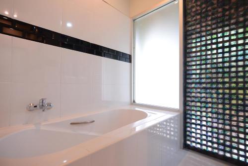 eine Badewanne im Bad mit Fenster in der Unterkunft Royal River Kwai Resort and Spa -SHA Extra Plus in Kanchanaburi