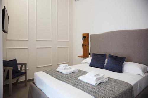 a bedroom with a bed with towels on it at Dimora Terranova Charming Rooms in Noto