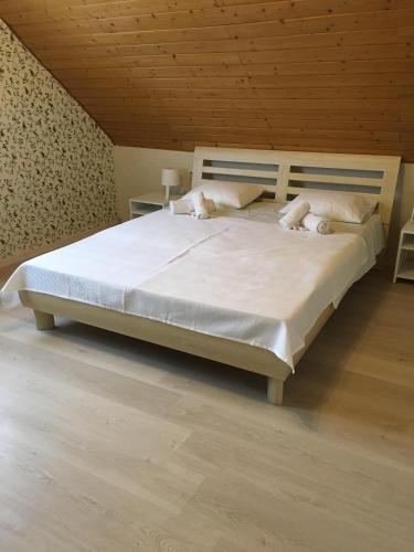 a bedroom with a bed with white sheets and pillows at Lavender in Hévíz