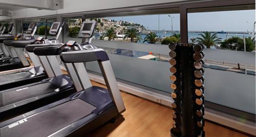a gym with treadmills and a view of the ocean at Airotel Galaxy in Kavala