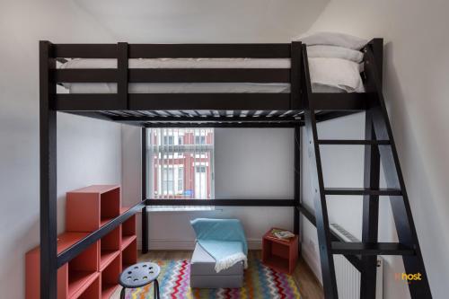 a bedroom with a bunk bed with a ladder at Host Liverpool - Artsy Stadium Suite, City Center & Garden in Liverpool