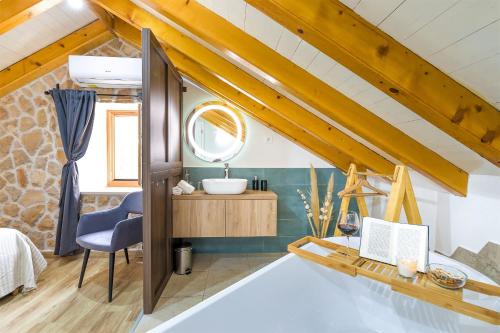 a bathroom in a loft conversion with a sink and a mirror at Villa Humac Hvar in Poljica