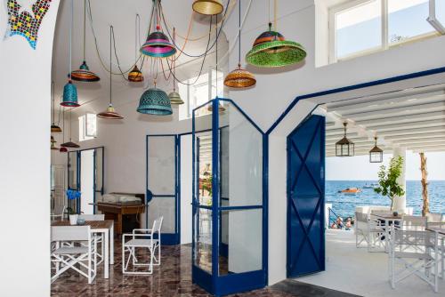 a room with a blue door and a view of the ocean at Laurito Beach Cucina & Camere in Positano