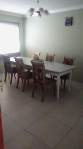 a dining room with a table and chairs at Emampingeni lodge in Bizana