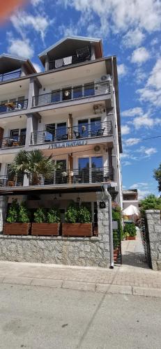 a large apartment building with plants in front of it at Villa Natali in Ohrid