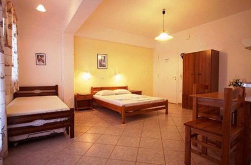 a large room with two beds and a table at Antonio Studios in Naxos Chora