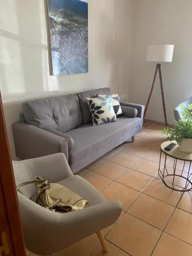a living room with a couch and a chair at Casa Rural San Francisco II in Siles
