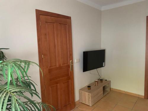 a room with a door and a tv on a wall at Casa Rural San Francisco II in Siles