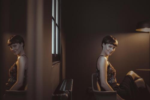 a woman sitting in a chair in front of a mirror at Boutique Hotel K7 in Bad Nauheim