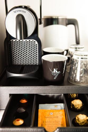 a kitchen drawer with a coffee pot and food at Boutique Hotel K7 in Bad Nauheim