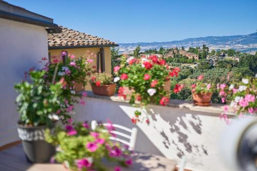 a balcony with potted plants and flowers on it at Casetta Bea in Celle sul Rigo