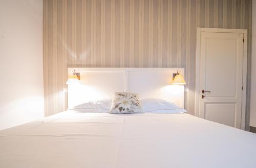 a white bed with a pillow on top of it at Agriturismo Il Sarale - Umbria in Città di Castello