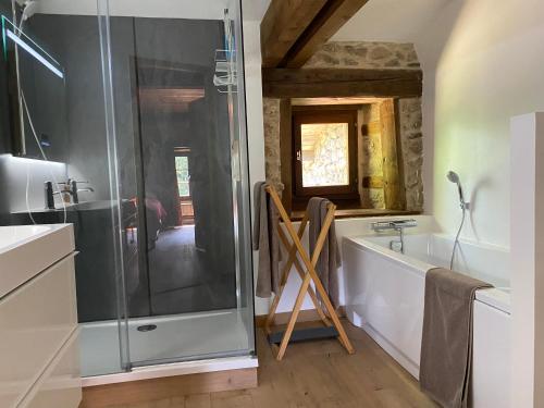 a bathroom with a shower and a bath tub at La Vaisse in Ambert