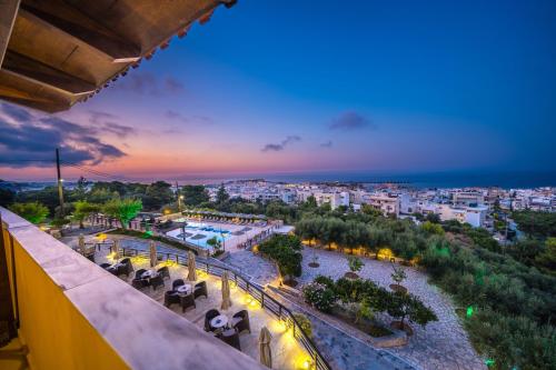 a view of a city at night from a building at Forest Park Hotel in Rethymno Town
