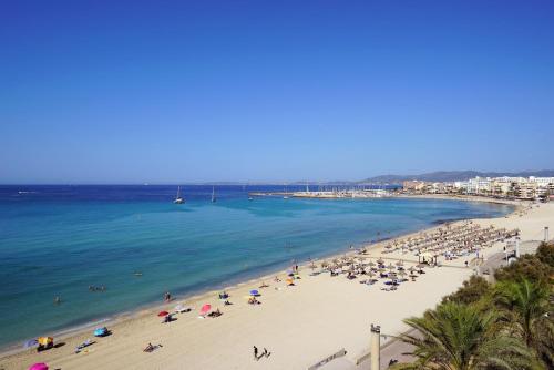 a beach with a lot of people and the ocean at Hotel Eden Palma Playa Adults Only in Can Pastilla