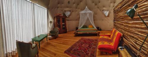 a living room with a bed in a log cabin at That's life Glamping - Dolomite Experience in Dorgnan