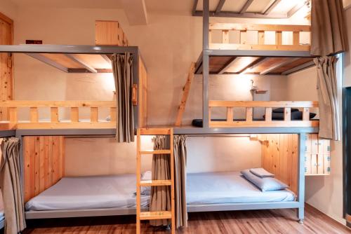 a group of bunk beds in a room at Yilan Inspiration in Luodong