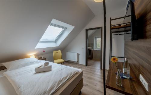 a bedroom with a bed with a towel on it at Hotel Zu Freunden in Hamm