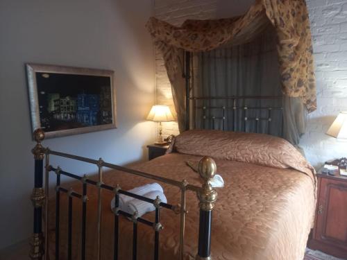 a bedroom with a bed with a canopy at Michael-Angelo guest house in Potchefstroom