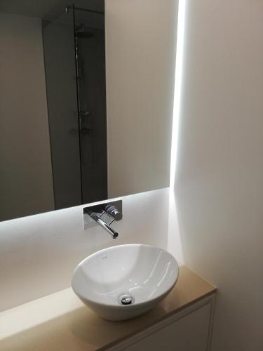 a white sink in a bathroom with a mirror at Aveiro Soul & Heart apartment in Aveiro