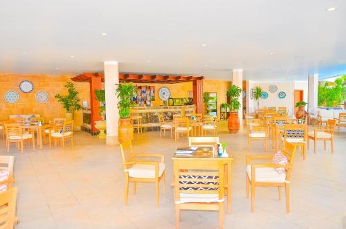 a restaurant with tables and chairs in a room at Steigenberger Hotel & Nelson Village, Taba in Taba