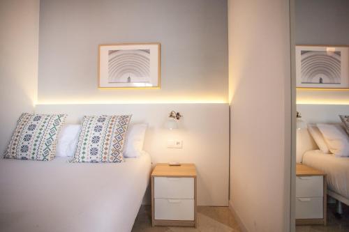 a room with a couch and a bed and a table at Gran Central Suites in Madrid