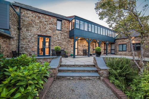 an exterior view of a brick building with a patio at Timber Hill - Parkfields in Haverfordwest